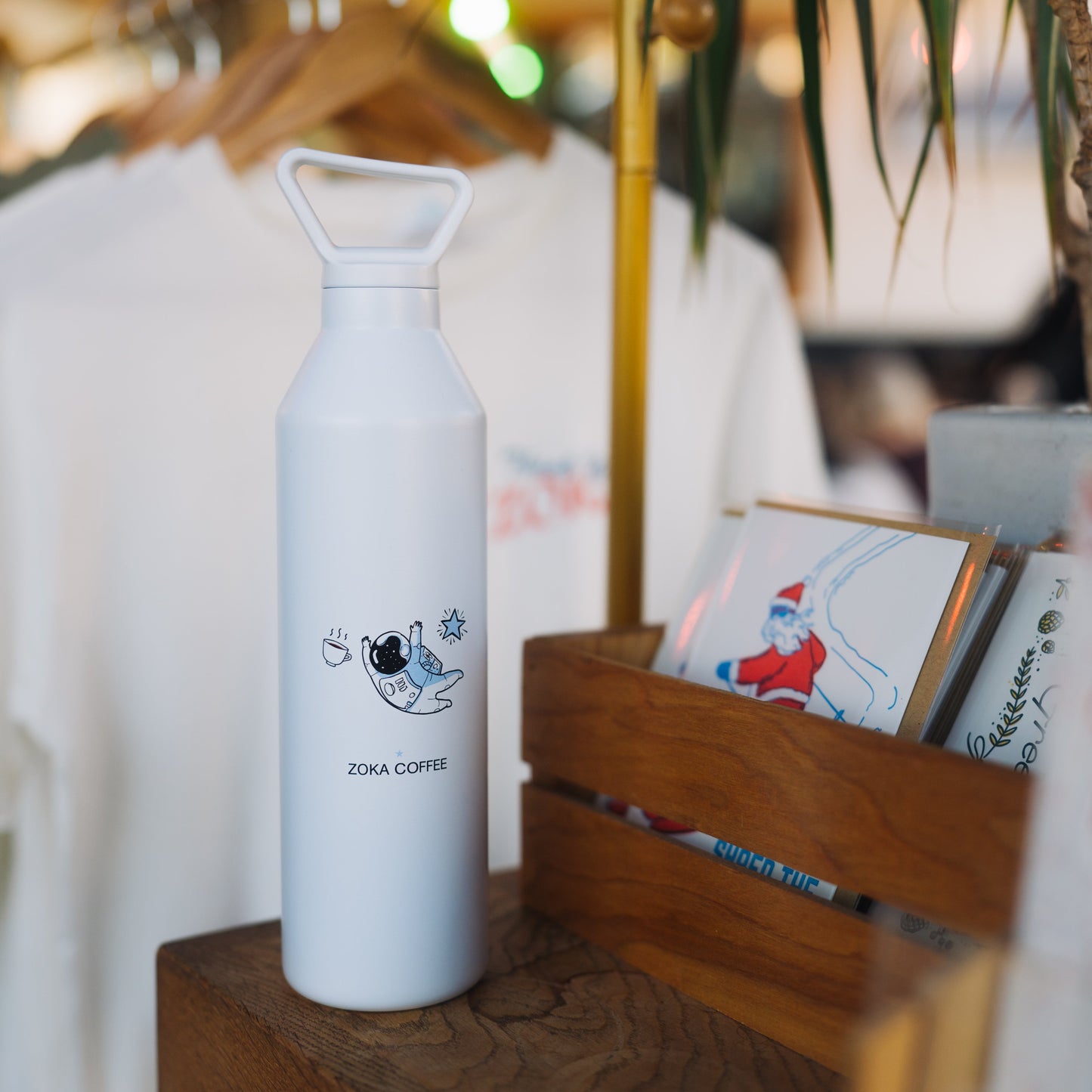 white tall skinny MiiWater Bottle with astronaut design and zoka logo